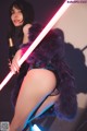 A woman in lingerie holding a bottle of champagne and a light saber.